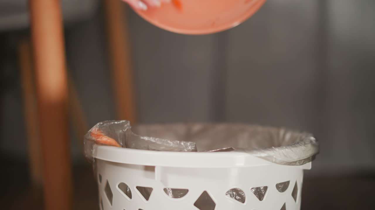 Throwing Food Scraps into Trash Bin