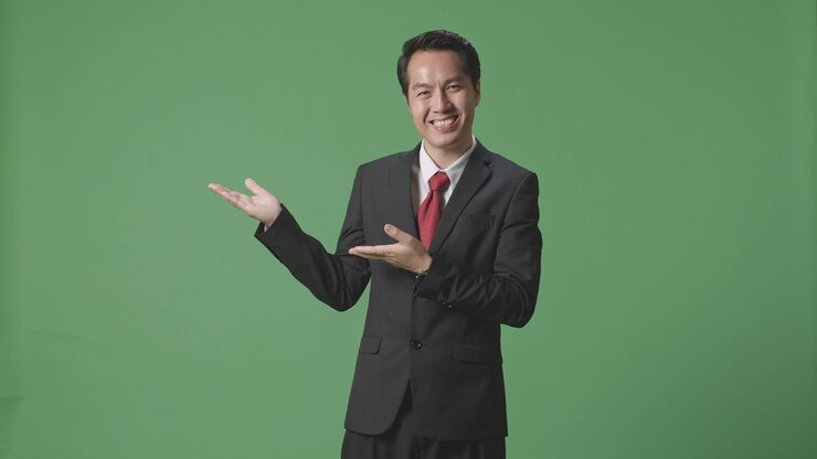 An Asian Business Man Showing Open Hand Palm While Standing In The Green Screen
