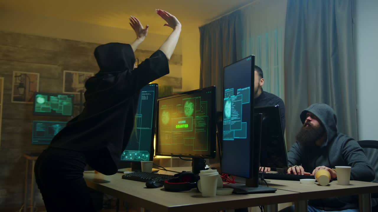 Team of cyber criminals celebrate after a successful hack