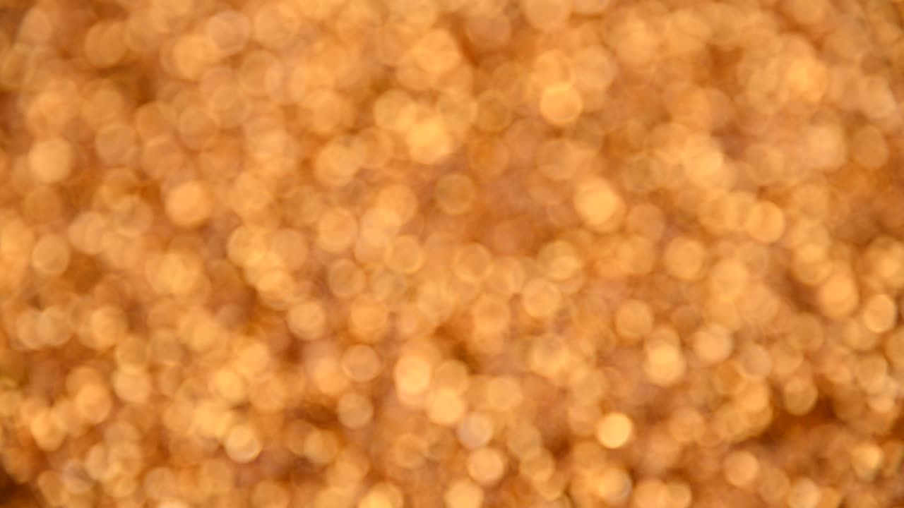 回転する金色のボケの抽象的な背景