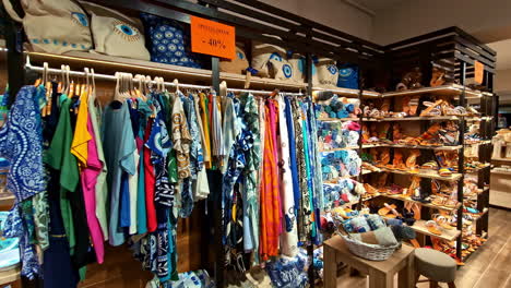 indoor view of traditional greek garments and souvenirs displayed in a shop.