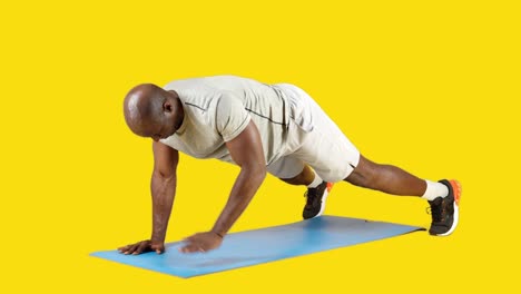 a man performing a workout exercise on a mat