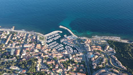 aerial shot flying towards sausset les pins residential area coastal city