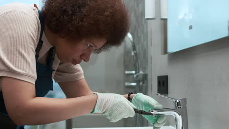 plumber fixing faucet