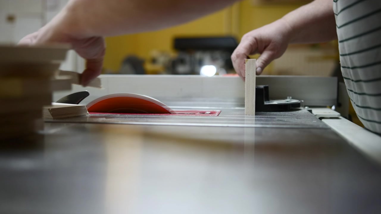 Hands Feeding Wood Through Table Saw, Rhythmic Rip Cutting Using Fence For Alignment, Stacks Of Panels. Media