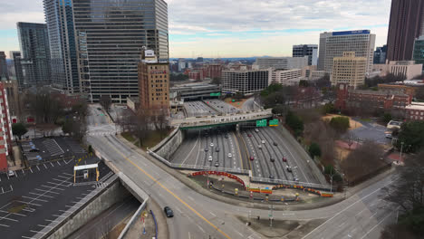 Aerial-view-of-Downtown-Atlanta-famous-landmark-Peachtree-Street-traffic-and-skyline-buildings-in-view,-Georgia,-USA