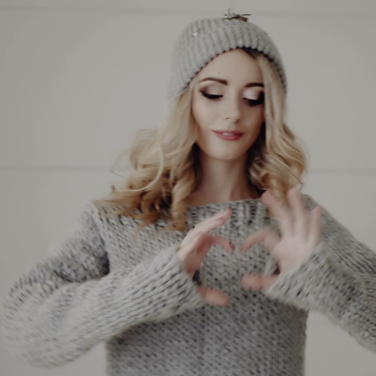 Woman showing heart shaped hands