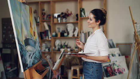 woman painting a canvas in a studio