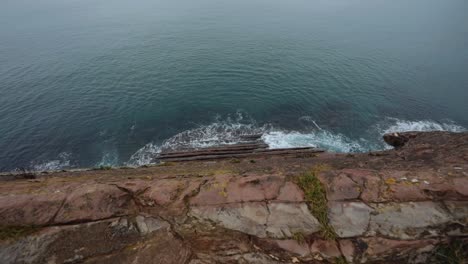 Aerial-view-of-waves-crashing-with-rocks