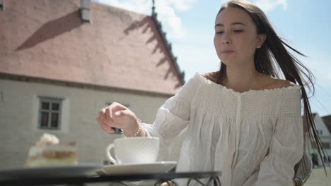 woman enjoying coffee and cake outdoors