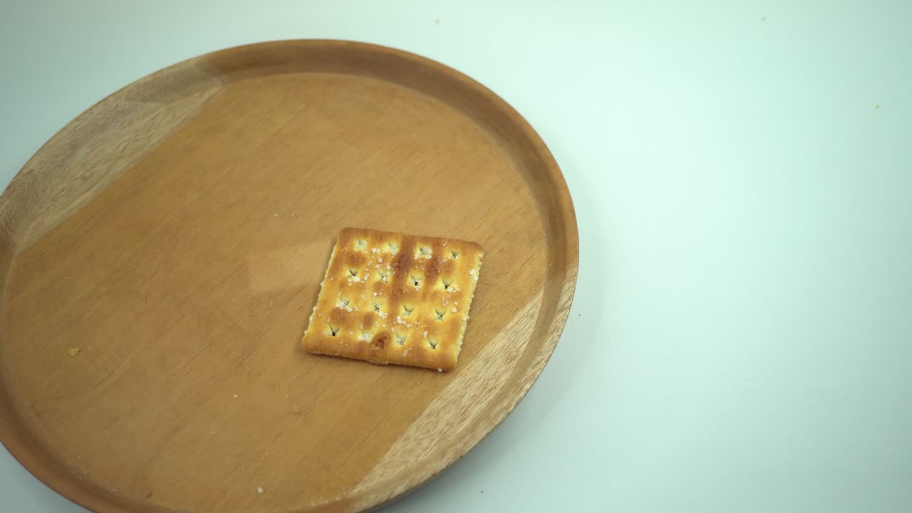 Christmas cracker biscuit over the wooden plate, fork and spoon with white background.