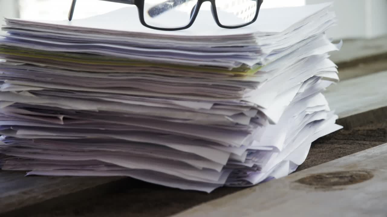 Close-up of spectacles on documents 4k