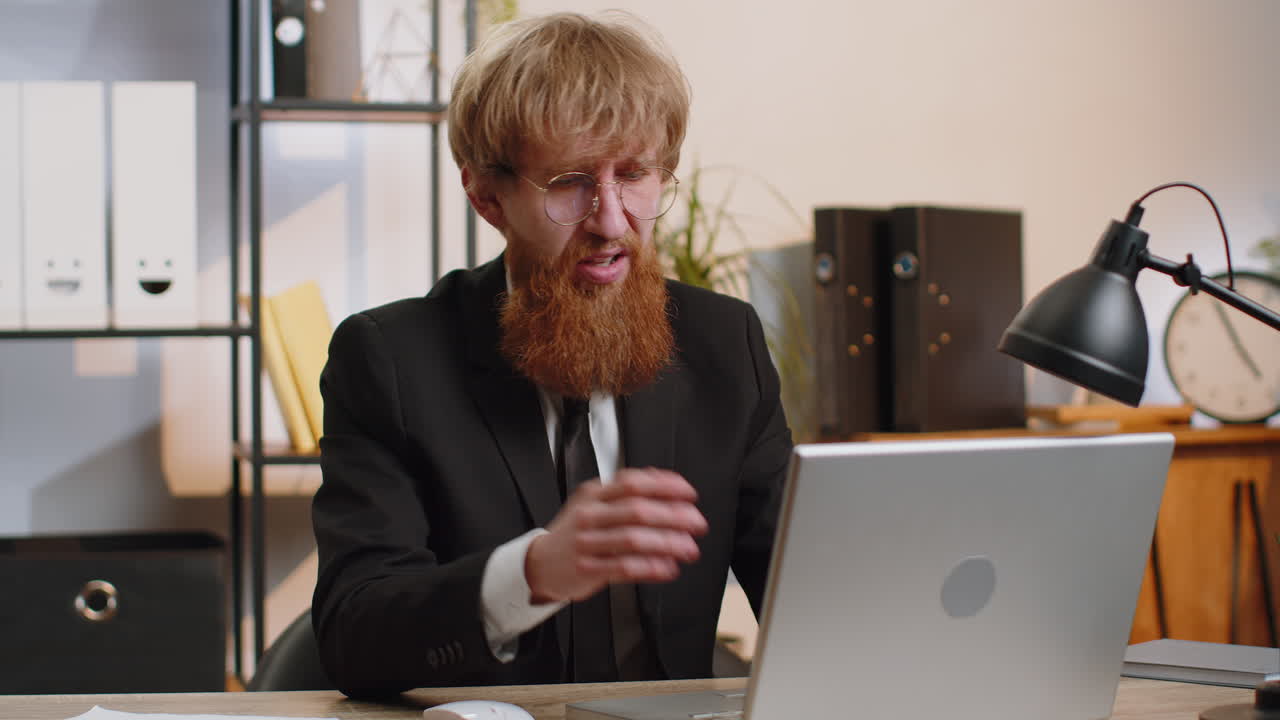 Business man working on laptop shakes finger saying no be careful giving advice to avoid mistake