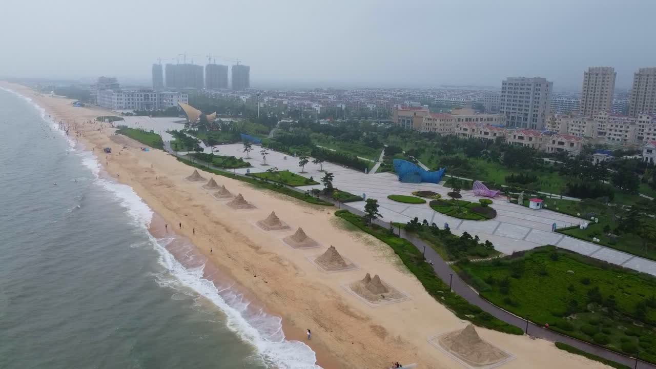 Nanhai beach and sand sculptures high sliding view
