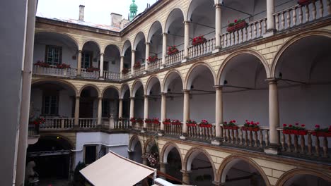 white italian courtyard with red roses in lviv ukraine