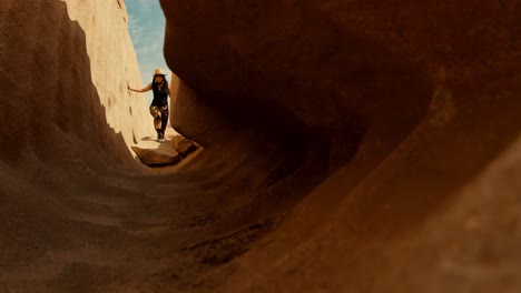 female-traveller-adventure-woman-walking-inside-the-unfinished-obelisk-in-the-northern-region-of-the-stone-quarries-of-ancient-Egypt-in-Aswan