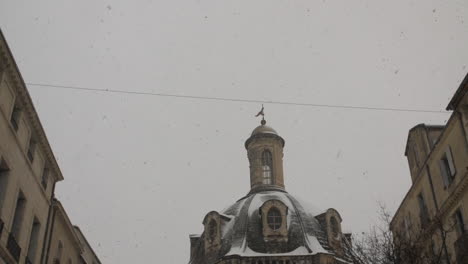Up-to-down-tilt-on-Saint-Come-hotel-in-Montpellier-France.-Snowy-day-winter-slow