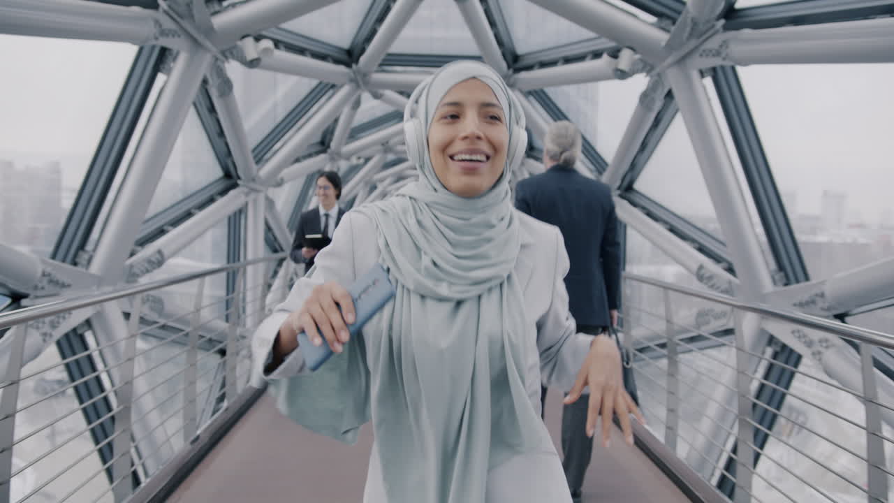 Woman in Hijab Dancing on a City Bridge