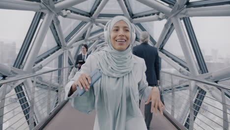 woman in hijab dancing on a city bridge