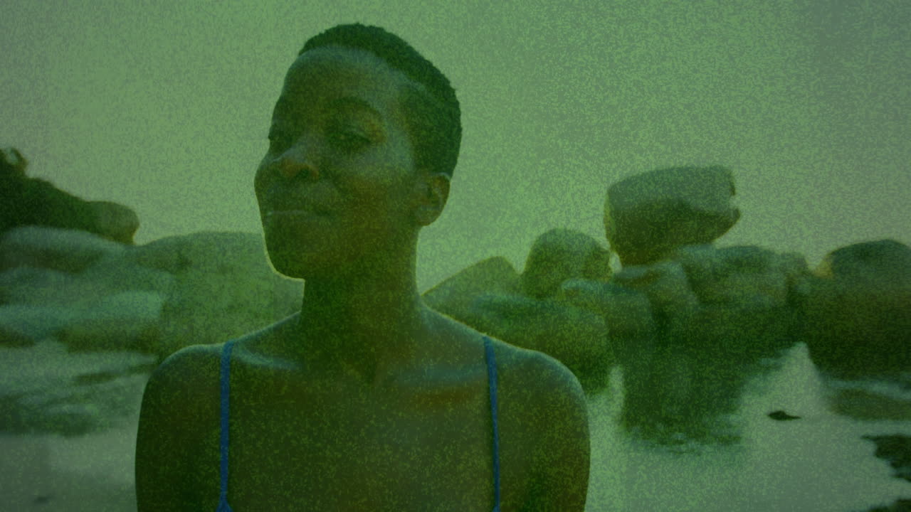 Wearing blue swimwear, person with abstract green animation texture overlay