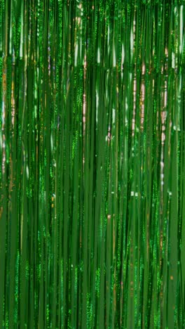 Vertical-Video-Full-Frame-Background-Shot-Of-Green-And-Gold-Tinsel-In-Studio-For-St-Patrick's-Day