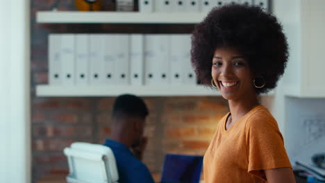 Portrait-Of-Young-Smiling-Businesswoman-Working-In-Modern-Office