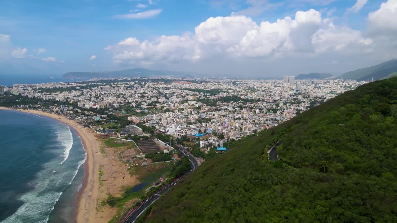 Aerial drone shot of Vizag city, showcasing its bustling streets and coastal beauty under a clear sky.