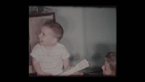 2 year old little boy plays toy guitar