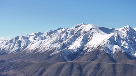 new zealand alpine landscape, mountain range covered in snow, winter season