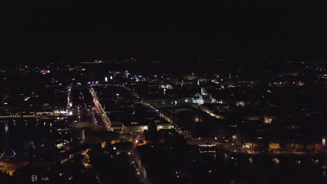 Aerial,-static,-drone-shot,-ovelooking-the-Kauppatori-market-square,-the-Helsinki-cathedral-and-buildings-and-streets,-in-the-Kruununhaka-area,-city-full-of-lights,-in-Uusimaa,-Finland