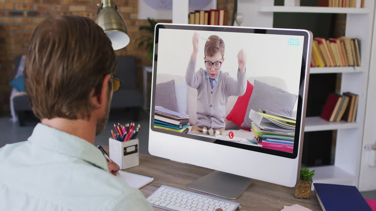 Caucasian male teacher using computer on video call with schoolboy