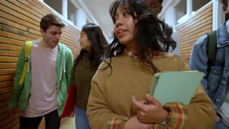 group of students walking in school hallway