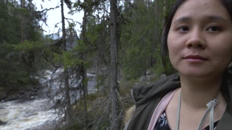 Girl-looking-at-a-river-in-the-forest