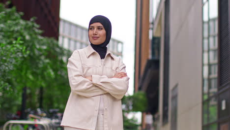 Portrait-Of-Modern-Muslim-Businesswoman-Wearing-Hijab-With-Business-Suit-Going-To-Work-Standing-Outside-Office-Building-With-Folded-Arms