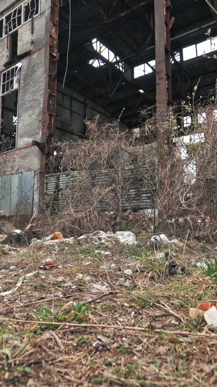 Industrial exterior of old factory building. Abandoned factory exterior and building waiting for a demolition Vertical video