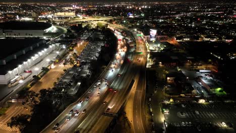 City-of-Los-Angeles,-traffic-on-Interstate-110-Freeway-at-night---aerial-flyover