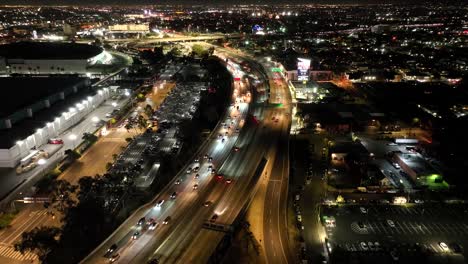 city of los angeles, traffic on interstate 110 freeway at night - aerial flyover