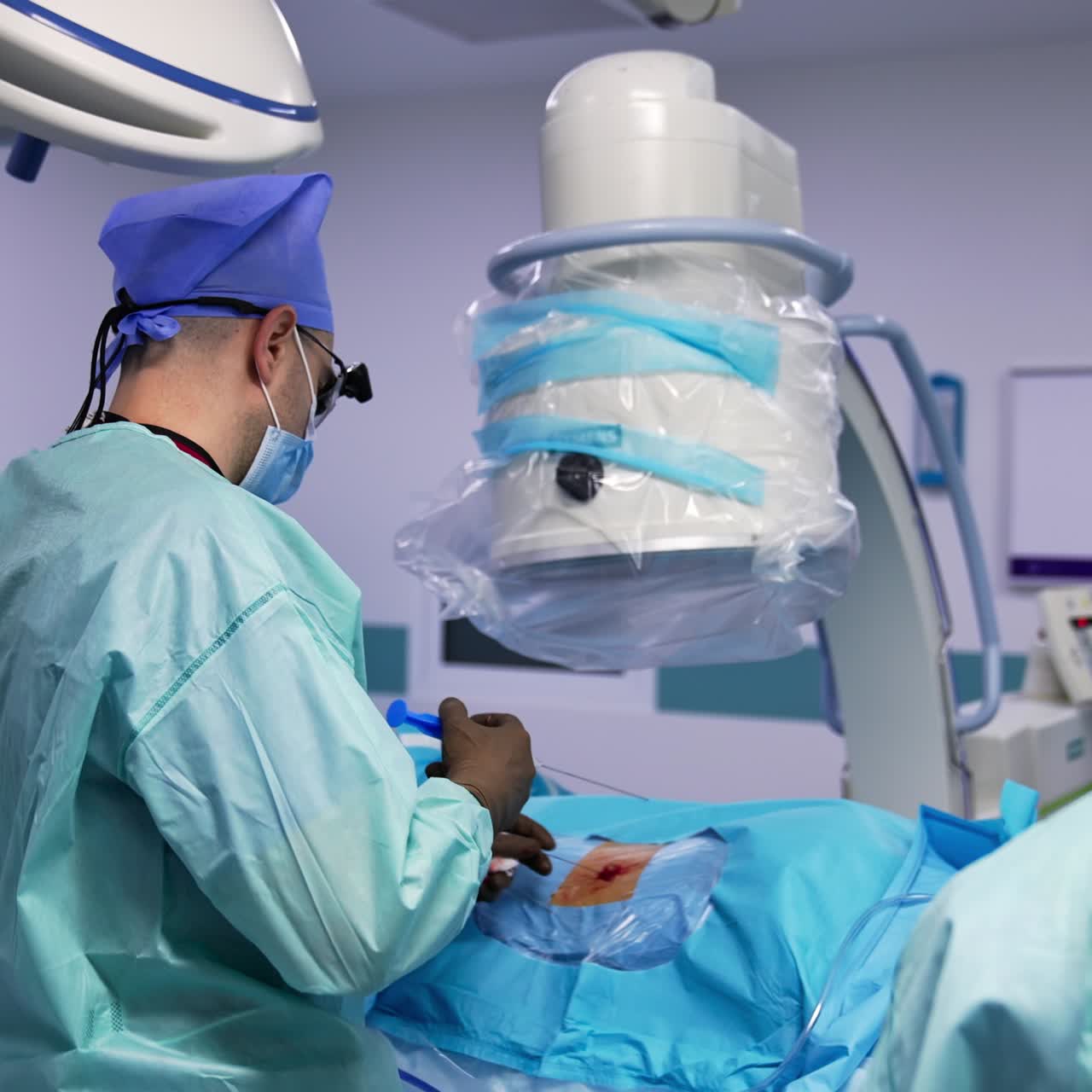 Surgical professional making infusion by a syringe with long needle. Male assistant standing at both sides from a doctor in a modern surgery room