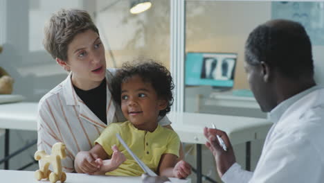 woman with little son consulting with doctor