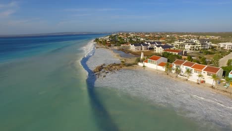 big waves damaging houses after a hurricane passed by at the coastline of bonaire