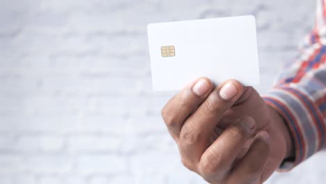 hand holding a blank white credit card