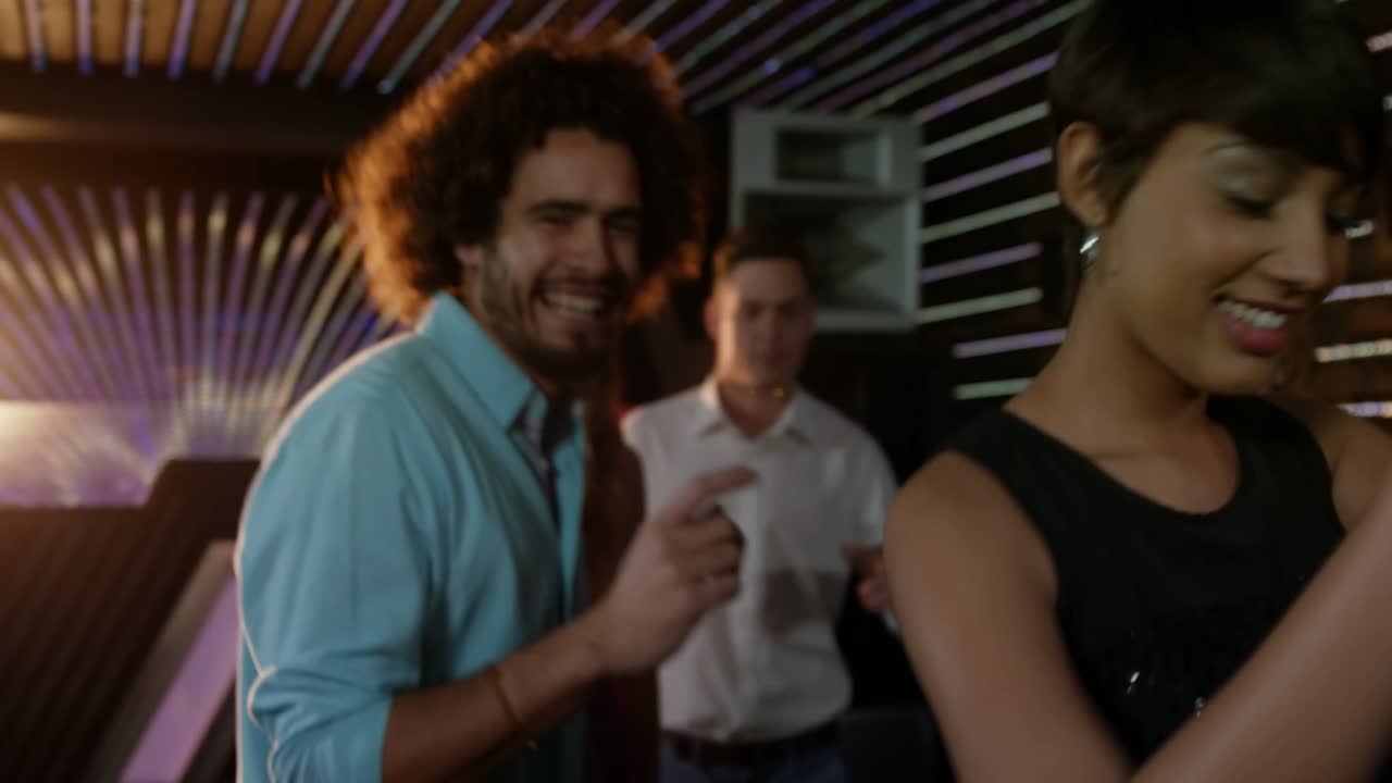 Group of friends dancing on dance floor