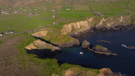 golden sunset light over dunquin pier, with dramatic skies and sea views - dingle co.kerry - 4k cinematic drone footage 10.