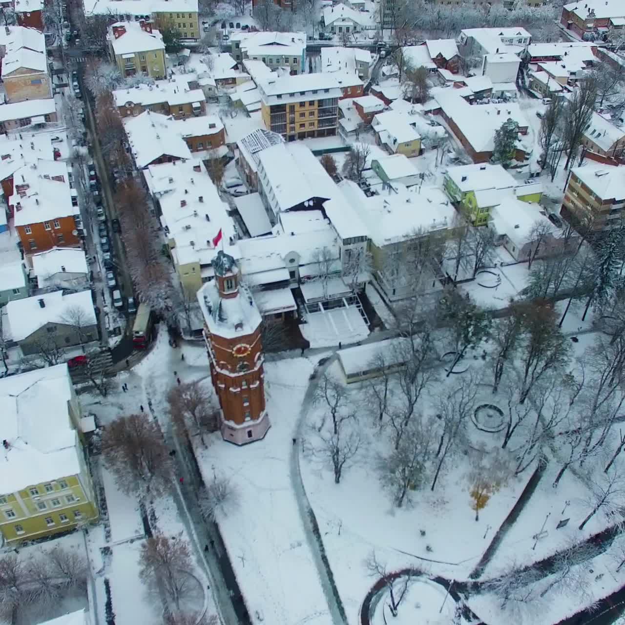 Panorama of the beautiful city covered with snow. Drone footage over the urban landscape on winter daytime