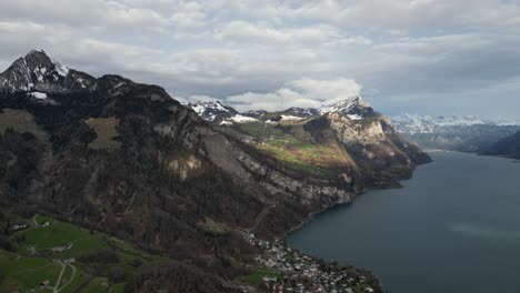 Panoramic-aerial-establishing-pan-above-sloping-curved-valley-and-ridgelines-with-Lake-Walen-and-cloud-shadows