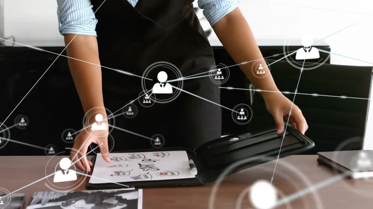 Animation of network of connections with people icons over caucasian businesswoman in office