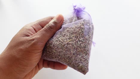 hand holding a lavender sachet