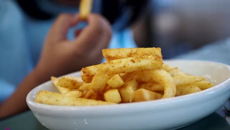 person eating french fries