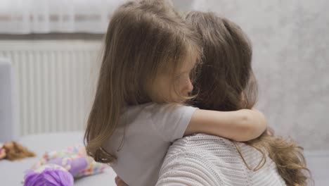 sad little girl hugging her mother. love of mother.