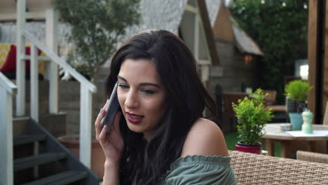 Portrait-of-smiling-woman-using-smartphone-to-make-a-call